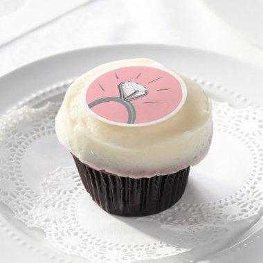 Diamond white gold engagement ring on pink edible frosting rounds