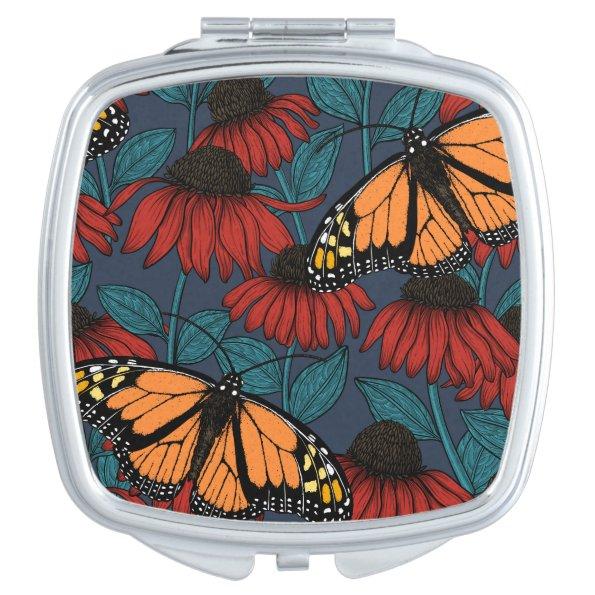 Monarch butterfly on red coneflowers compact mirror