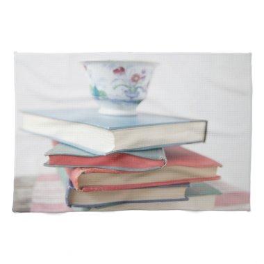 Teacup on book stack towel